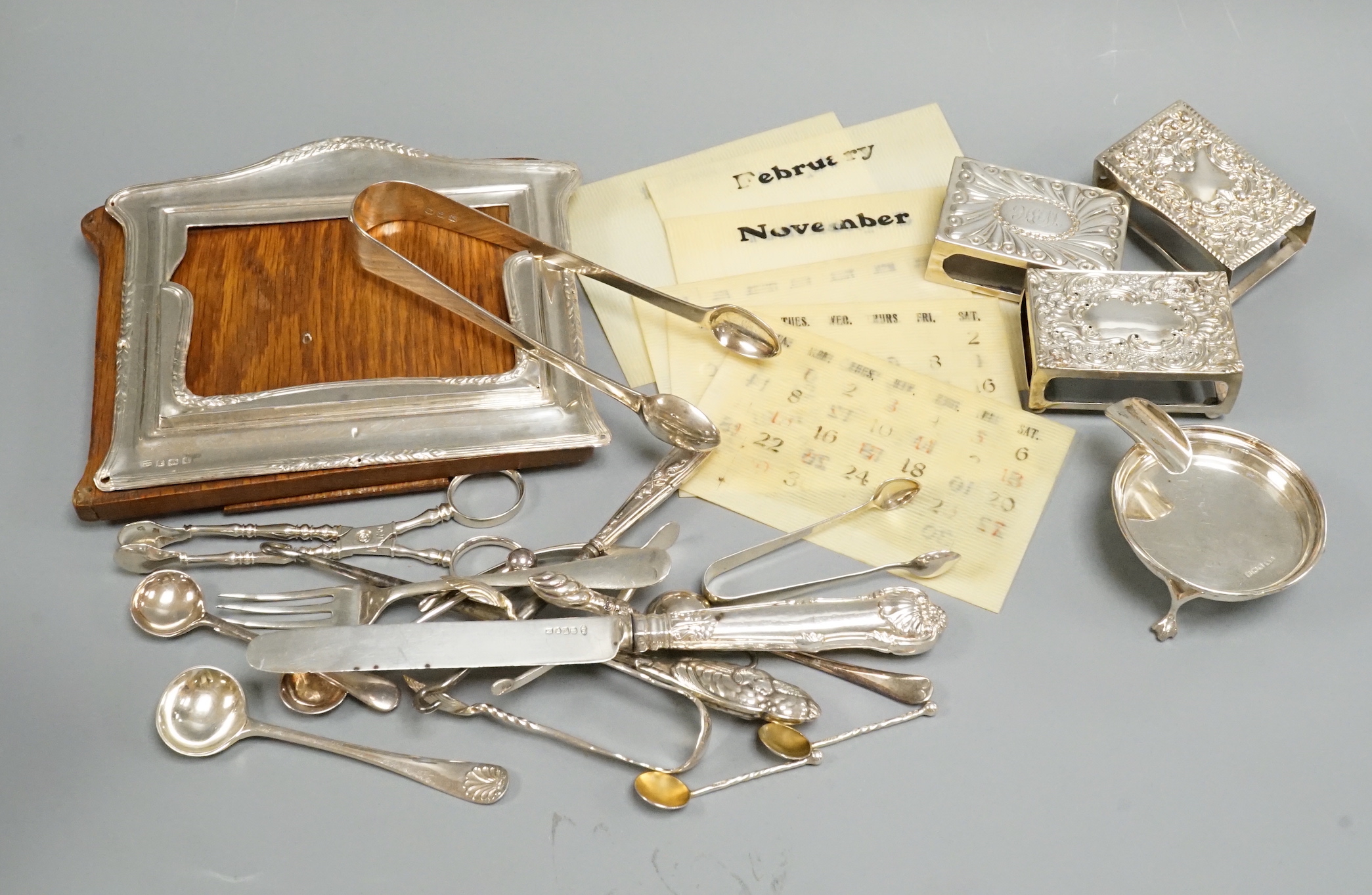 Sundry small silver including flatware, mounted calendar frame(a.f.), matchbox sleeves etc.